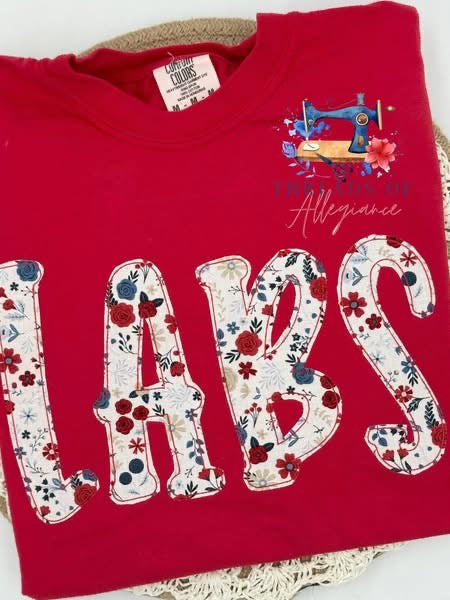 Red garment with LABS red, white & blue floral fabric