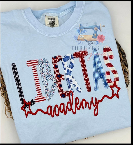 Light blue garment with LIBERTAS In fabric mixture and “patriots””
