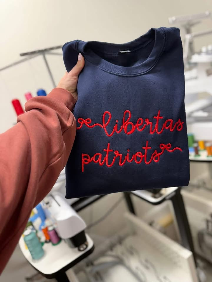 Navy garment with Libertas patriots in red thread