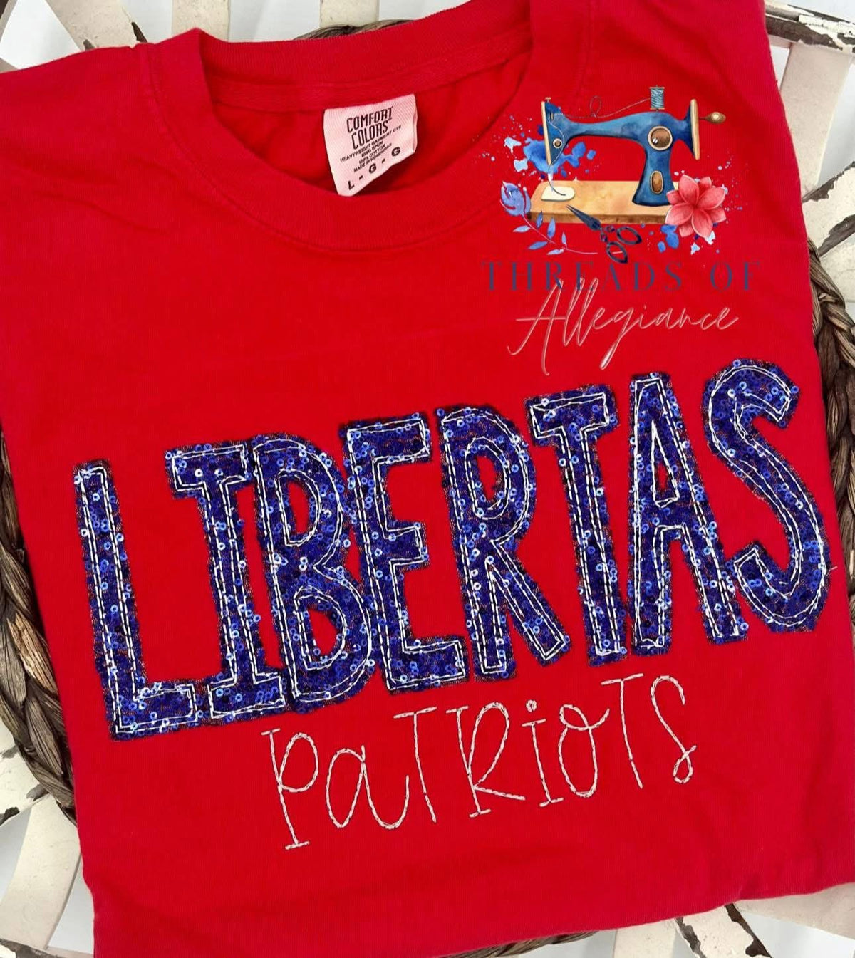 Red garment with royal sequins “LIBERTAS”