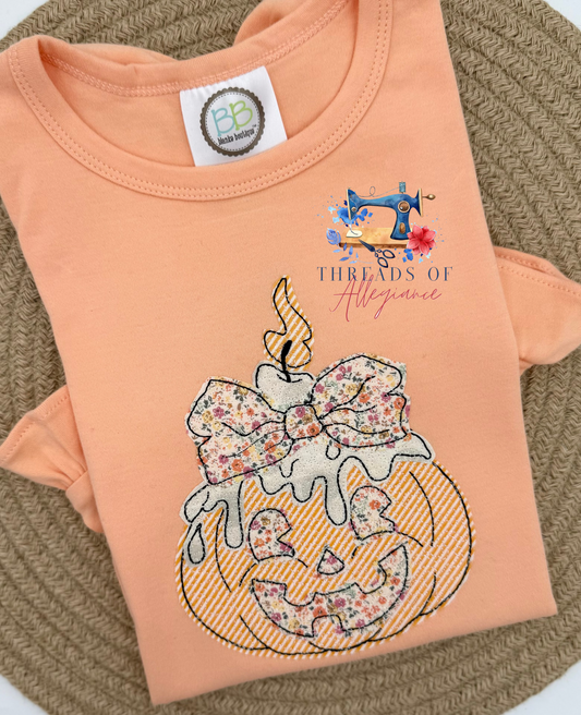 Quilted jack-o’-lantern with bow